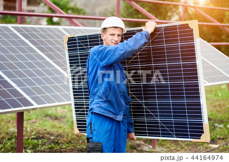 Installation of stand-alone exterior photo voltaic panels system. Renewable green energy generation. Installation of stand-alone exterior photo voltaic panels system. Renewable green energy generation. 44164974