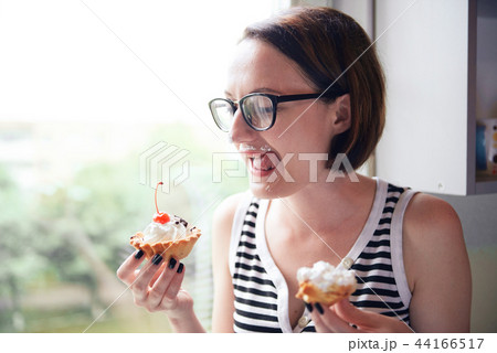 girl eating tasty cakes, sweet food and pleasure 44166517