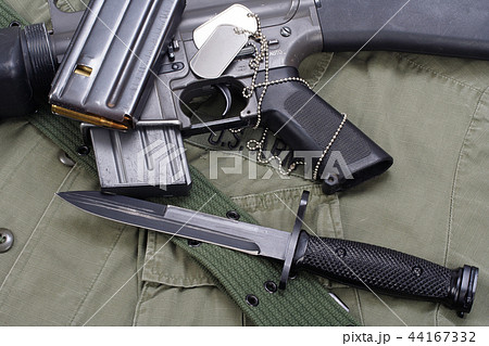 M16 rifle bayonet on uniform bacground 44167332