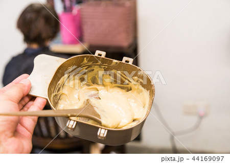 Hair dresser apply chemical color dye onto hair Hair dresser apply chemical color dye onto hair 44169097