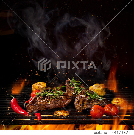 Beef steaks on the grill with flames Beef steaks on the grill with flames 44173329