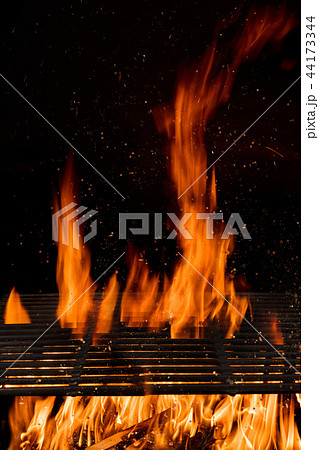 Empty flaming charcoal grill with open fire. 44173344
