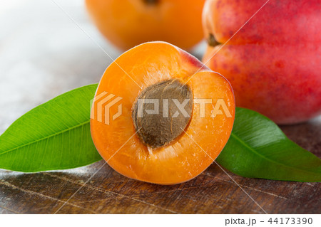 Fresh apricots on a white wooden background. 44173390