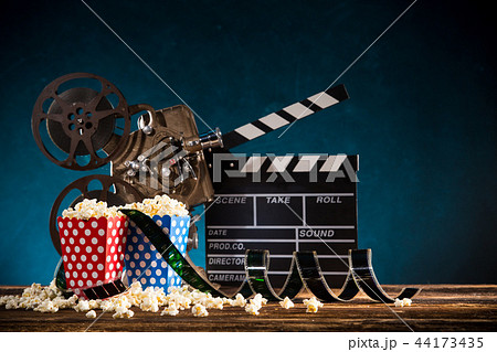 Cinema concept of vintage film reel with popcorn. Cinema concept of vintage film reel with popcorn. 44173435