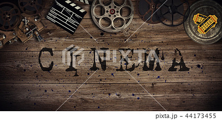 Cinema concept of vintage film reels, clapperboard and projector. Cinema concept of vintage film reels, clapperboard and projector. 44173455