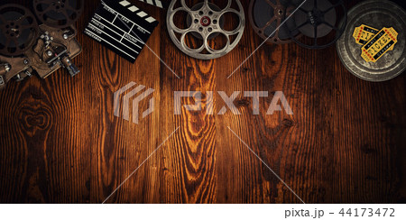 Cinema concept of vintage film reels, clapperboard and projector. 44173472