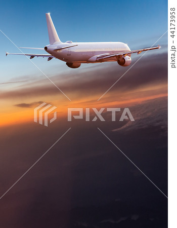 Commercial airplane flying above dramatic clouds. Commercial airplane flying above dramatic clouds. 44173958