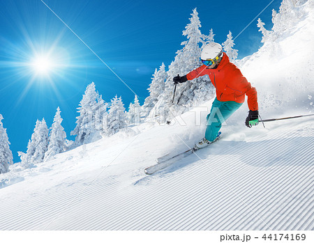 Skier skiing downhill in high mountains Skier skiing downhill in high mountains 44174169