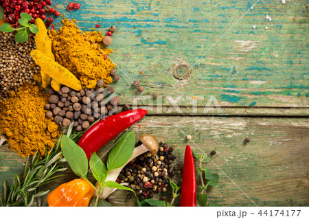 Various colorful spices on wooden table 44174177