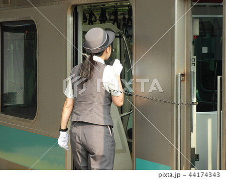 放送の音量確認をする女性車掌さんの写真素材