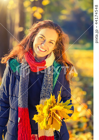 Portrait of young beautiful woman in autumn park Portrait of young beautiful woman in autumn park 44174548