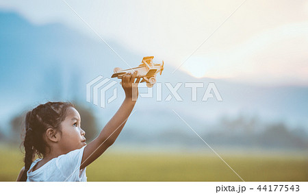 asian child girl playing with toy wooden airplane 44177543