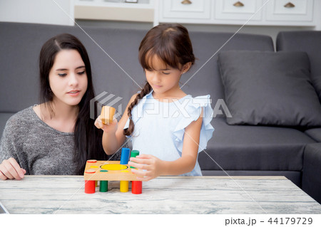 Mother and child play toy together 44179729