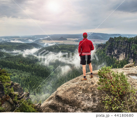 Tall man with cap, red jumper and pants hiking Tall man with cap, red jumper and pants hiking 44180680
