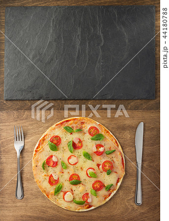 pizza at wooden table and slate stone pizza at wooden table and slate stone 44180788