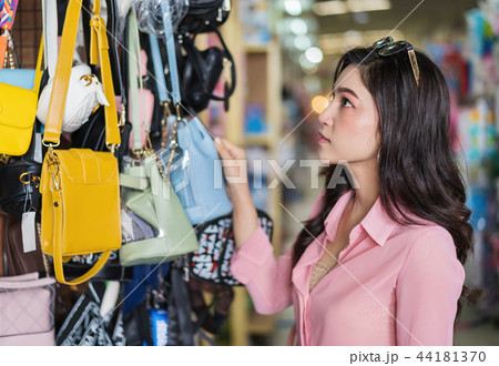 woman choosing and shopping handbag in store 44181370