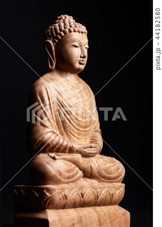 Buddha in a meditation pose, made of wood. 44182580
