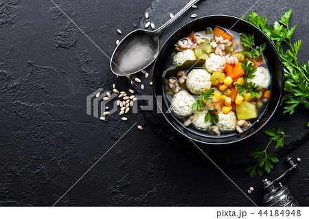 Delicious vegetable soup with chicken meatballs 44184948