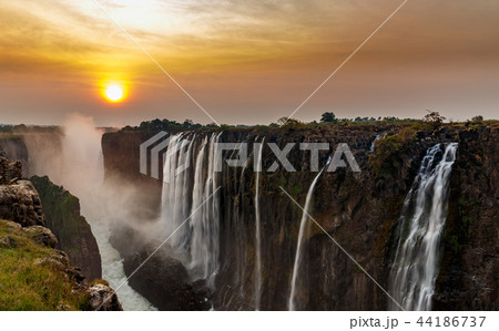 Victoria falls dreamy sunset panorama with orange Victoria falls dreamy sunset panorama with orange 44186737