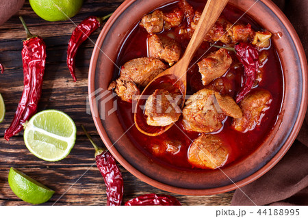 Carne Adobada in a clay bowl 44188995