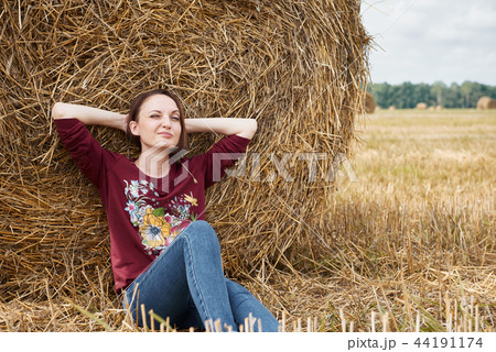 young girl having fun in the field with haystack young girl having fun in the field with haystack 44191174