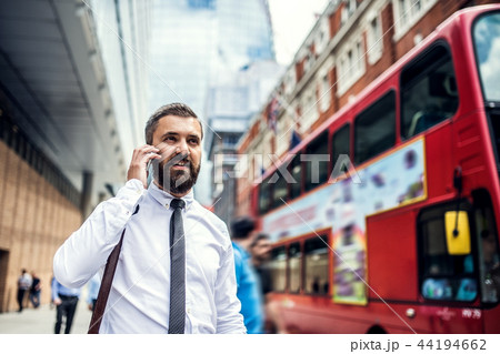 Hipster businessman on the street in London, making a phone call. Hipster businessman on the street in London, making a phone call. 44194662