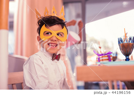 Happy boy wearing paper mask and looking ready for party Happy boy wearing paper mask and looking ready for party 44196156
