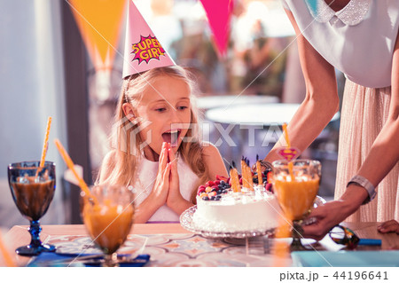 Impressed girl clapping her hands while looking at the beautiful cake Impressed girl clapping her hands while looking at the beautiful cake 44196641
