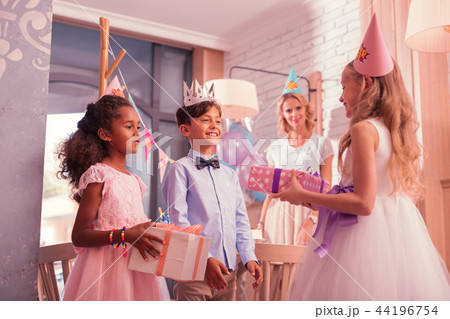 Birthday girl feeling happy while getting presents from friends 44196754