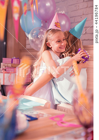 Cute girl smiling and feeling thankful while hugging mother 44196784