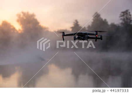 Drone copter with digital camera, river on background. Modern technology, UAV concept. Drone copter with digital camera, river on background. Modern technology, UAV concept. 44197333