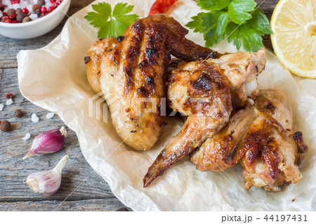 Chicken wings baked on grill on wooden background 44197431