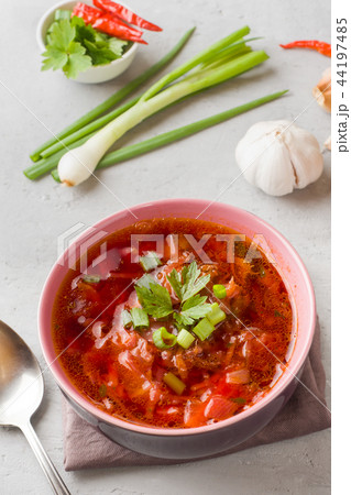 Borsch, beetroot soup in a wooden bowl with fresh  44197485