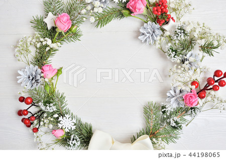 Mockup of Christmas Wreath Made of Naturalistic Looking Pine Branches Decorated with Red Berries and 44198065