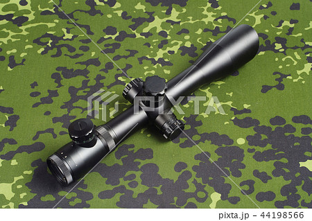 sniper scope on camouflage background sniper scope on camouflage background 44198566