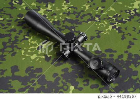 sniper scope on camouflage background sniper scope on camouflage background 44198567