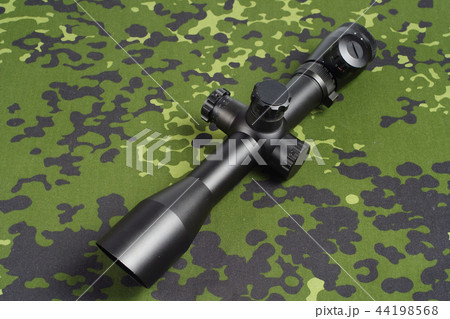 sniper scope on camouflage background 44198568