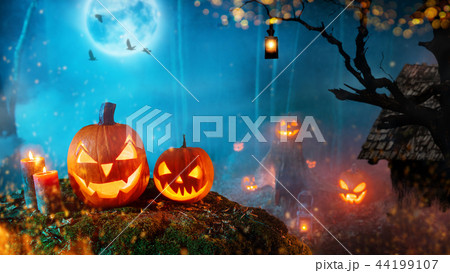 Spooky halloween pumpkins in dark mistery forest Spooky halloween pumpkins in dark mistery forest 44199107
