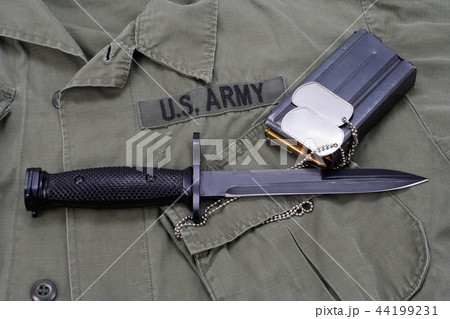 M16 rifle bayonet on uniform background 44199231