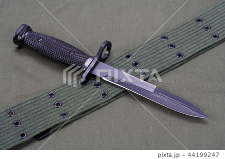 M16 rifle bayonet on uniform background 44199247