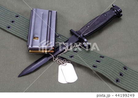 M16 rifle bayonet on uniform background 44199249