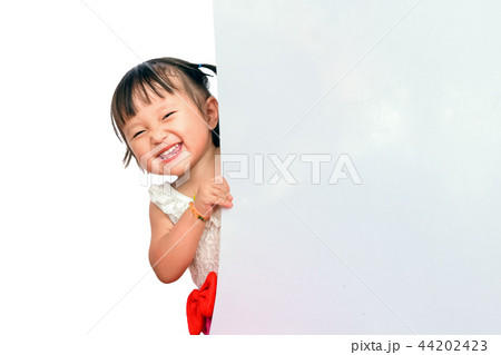 Happy Little asian children smile peeking out behind board. Space for copy composition for , website 44202423