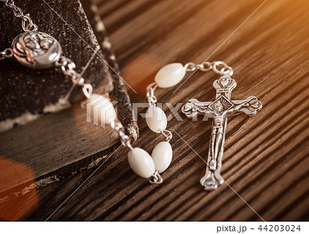 Closeup of iron Christian cross with holy Bible. 44203024