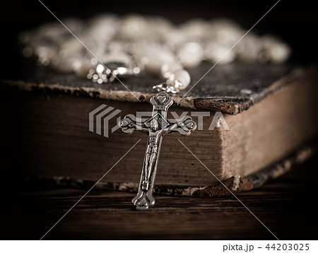 Closeup of iron Christian cross with holy Bible. Closeup of iron Christian cross with holy Bible. 44203025