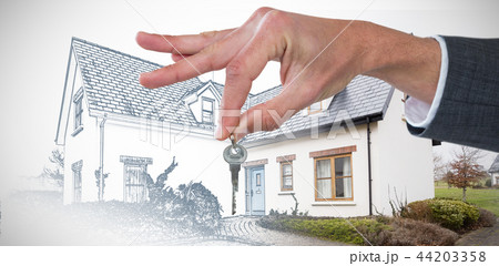 Composite image of cropped hand of businessman holding key 44203358