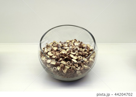 Chinese traditional medicine, dry leaves in glass bowl white isolated background. 092 Chinese traditional medicine, dry leaves in glass bowl white isolated background. 092 44204702