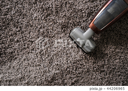 Close-up Of man  using A Vacuum Cleaner 44206965