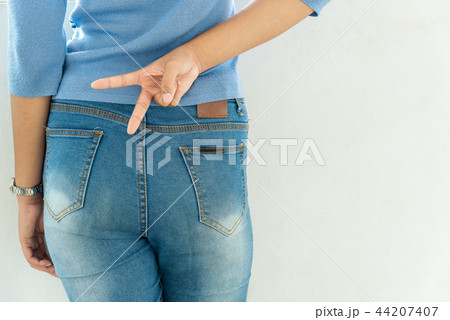 Young slim woman holds two fingers, victory sign. 44207407