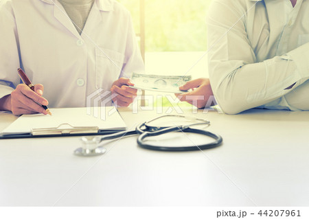 Business man or patient give bribe to the docto 44207961