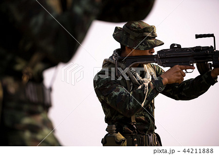 Soldiers patrolling across the deep forest area. Soldiers patrolling across the deep forest area. 44211888